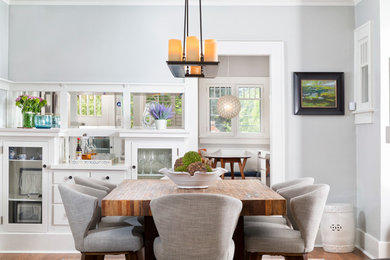 This is an example of a transitional dining room in Denver with grey walls and dark hardwood floors.