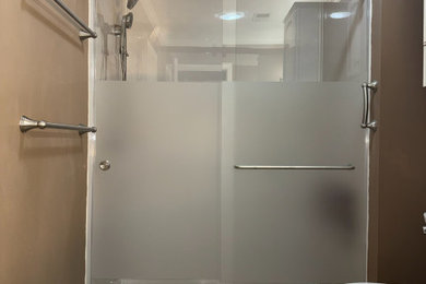 Bathroom - small modern 3/4 vinyl floor and brown floor bathroom idea in Other with a two-piece toilet and brown walls