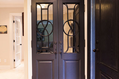 Example of a mid-sized transitional ceramic tile entryway design in Toronto with beige walls and a dark wood front door