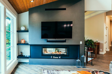 Living room - huge rustic open concept medium tone wood floor, brown floor and wood ceiling living room idea in Vancouver with a bar, multicolored walls, a plaster fireplace and a wall-mounted tv