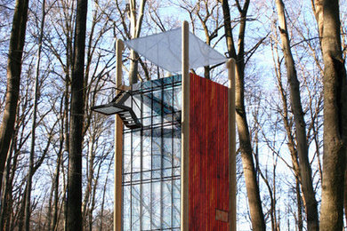 Inspiration for a small contemporary brown three-story wood flat roof remodel in Philadelphia