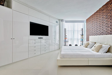This is an example of a mid-sized contemporary master bedroom in Miami with white walls and concrete floors.