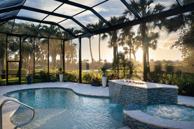 Example of a large minimalist backyard stone and custom-shaped pool fountain design in Miami