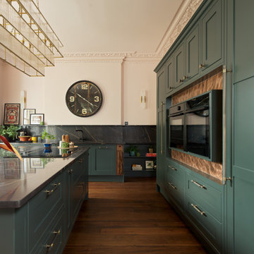 Deep green kitchen with warm metallic accents