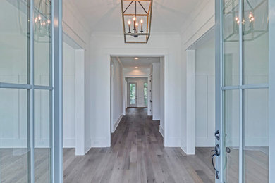 Inspiration for a light wood floor double front door remodel in Charleston with white walls and a blue front door