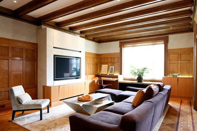 Photo of a mid-sized contemporary living room in Auckland with beige walls, medium hardwood floors and a built-in media wall.