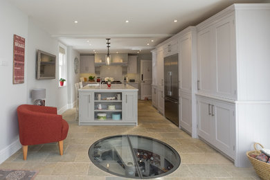 Inspiration for a large contemporary galley separate kitchen in Hampshire with a farmhouse sink, shaker cabinets, grey cabinets, quartzite benchtops, white splashback, stainless steel appliances, limestone floors, with island, multi-coloured floor and white benchtop.