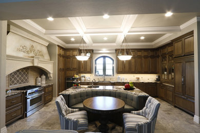 Inspiration for a large timeless u-shaped eat-in kitchen remodel in Tampa with recessed-panel cabinets, dark wood cabinets, granite countertops, paneled appliances and an island