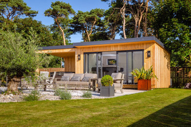 Design ideas for a medium sized back full sun garden for summer in Edinburgh with natural stone paving.