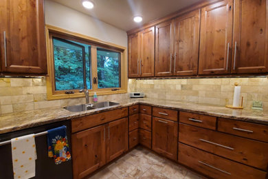 Inspiration for a small transitional porcelain tile and beige floor kitchen remodel in Other with an undermount sink, recessed-panel cabinets, brown cabinets, laminate countertops, beige backsplash, porcelain backsplash, stainless steel appliances, no island and brown countertops