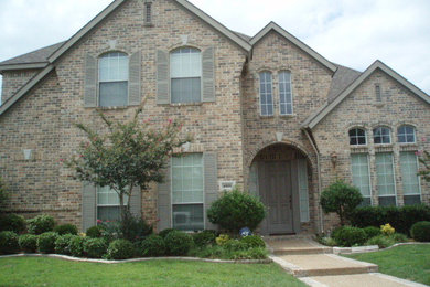 Design ideas for a large traditional two-storey beige exterior in Dallas with a hip roof.