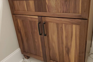 Mountain style bathroom photo in Boston with recessed-panel cabinets and a built-in vanity