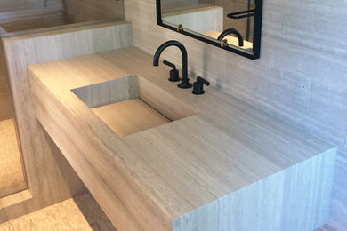 Design ideas for a mid-sized contemporary bathroom in San Francisco with an integrated sink, marble benchtops, gray tile, grey walls, mosaic tile floors, grey cabinets, an alcove shower, grey floor, a hinged shower door, grey benchtops, a shower seat, a single vanity, a floating vanity and marble.