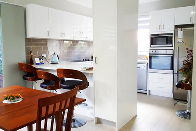 Small traditional u-shaped eat-in kitchen in Sydney with open cabinets, white cabinets, quartz benchtops, brown splashback, ceramic splashback, stainless steel appliances, ceramic floors and no island.