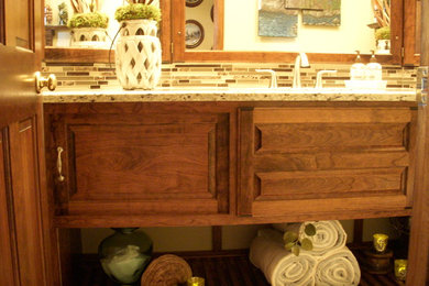 Beach style 3/4 beige tile bathroom photo in Minneapolis with raised-panel cabinets, medium tone wood cabinets and granite countertops