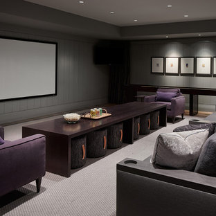 Example of a trendy carpeted and gray floor home theater design in Chicago with gray walls