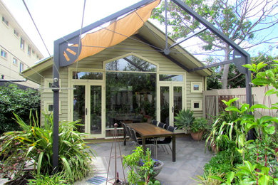 Photo of a mid-sized transitional backyard patio in Melbourne with concrete pavers and a pergola.