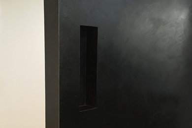 Example of a trendy entryway design in New York with a black front door