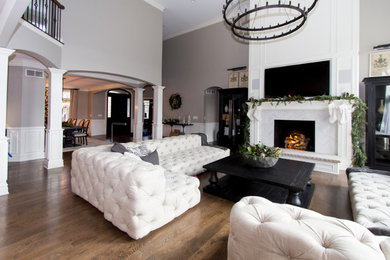 Large transitional formal and open concept light wood floor and brown floor living room photo in Chicago with a tile fireplace, a media wall, gray walls and a standard fireplace
