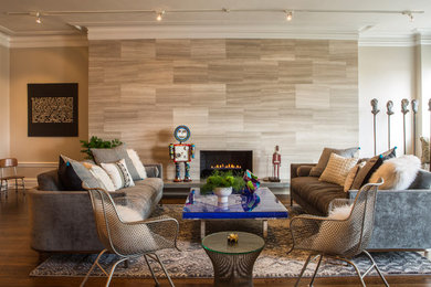 Inspiration for a contemporary open concept medium tone wood floor and brown floor living room remodel in Chicago with beige walls, a standard fireplace and a stone fireplace
