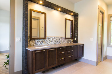 This is an example of a modern master bathroom in Other with an undermount sink, furniture-like cabinets, dark wood cabinets and granite benchtops.
