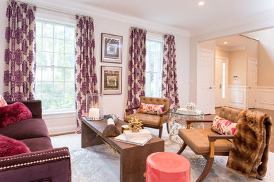 Example of a mid-sized transitional enclosed medium tone wood floor living room design in New York with beige walls and no tv