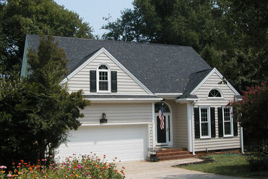 Inspiration for a mid-sized traditional two-storey beige exterior in Raleigh with a hip roof.