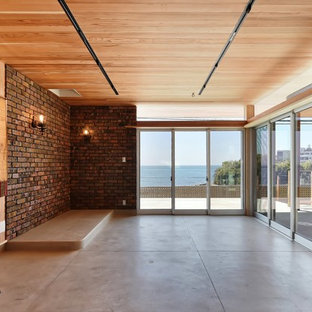 Modern home office and library in Other with beige walls, concrete flooring, a wood burning stove and a brick fireplace surround.