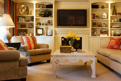 Mid-sized elegant enclosed carpeted family room photo in Portland with a standard fireplace, a brick fireplace, beige walls and a wall-mounted tv