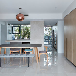 Design ideas for a mid-sized modern kitchen/dining combo in Brisbane with porcelain floors, grey floor and white walls.