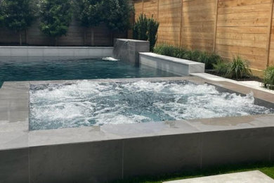 Inspiration for a transitional side yard rectangular pool remodel in Houston