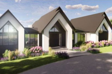 Example of a large minimalist gray two-story stucco house exterior design in Other with a metal roof and a black roof
