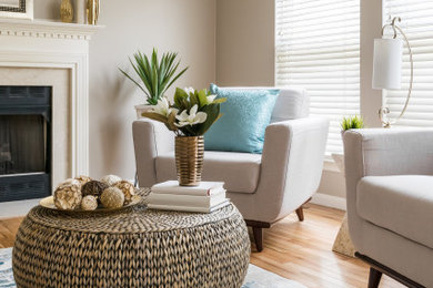 Mid-sized transitional open concept medium tone wood floor and beige floor family room photo in St Louis with gray walls, a standard fireplace, a tile fireplace and no tv