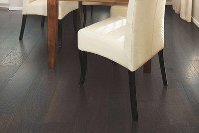 Inspiration for a timeless dark wood floor and brown floor dining room remodel in Denver with beige walls and no fireplace