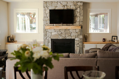 Inspiration for an arts and crafts living room in Vancouver with grey walls and a stone fireplace surround.