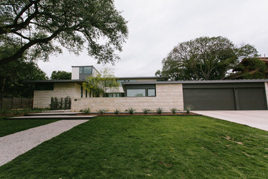 Huge trendy beige two-story mixed siding exterior home photo in Austin with a metal roof