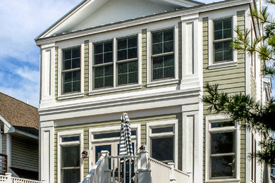 Inspiration for a mid-sized contemporary green two-story house exterior remodel in Other