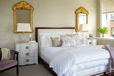 Design ideas for a transitional master bedroom in New York with beige walls and carpet.