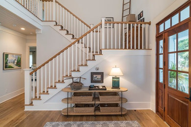 Inspiration for a mid-sized country light wood floor entryway remodel in Atlanta with white walls and a medium wood front door