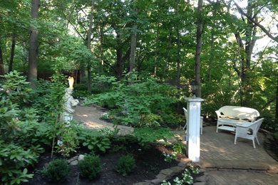 Design ideas for a large rustic shade backyard concrete paver formal garden in New York.