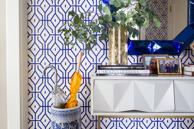 Inspiration for a small transitional light wood floor entryway remodel in New York with blue walls