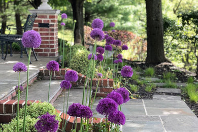 This is an example of a large traditional partial sun backyard stone walkway in Other.