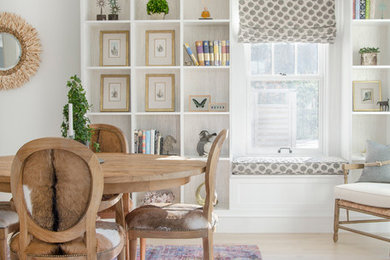 Example of a transitional light wood floor dining room design in Chicago with white walls
