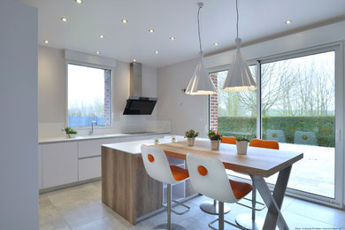 Photo of a mid-sized contemporary single-wall separate kitchen in Other with a single-bowl sink, flat-panel cabinets, wood benchtops, white splashback, ceramic floors, with island, grey floor and white benchtop.