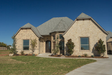 Mid-sized transitional beige one-story stone exterior home idea in Oklahoma City with a clipped gable roof