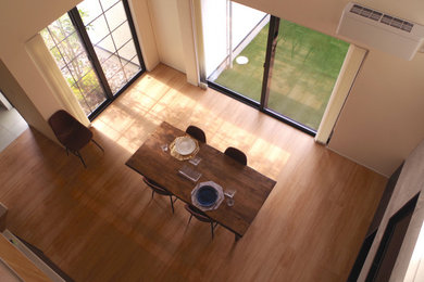 Photo of a contemporary dining room in Osaka with plywood flooring and no fireplace.