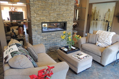 Small minimalist open concept ceramic tile living room photo in St Louis with brown walls, a two-sided fireplace and a stone fireplace