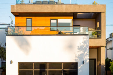 Inspiration for a large modern three-storey house exterior in Los Angeles with mixed siding and a flat roof.
