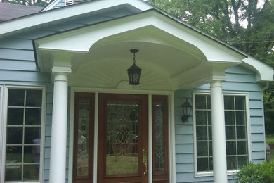 Inspiration for a mid-sized timeless blue two-story wood gable roof remodel in Philadelphia