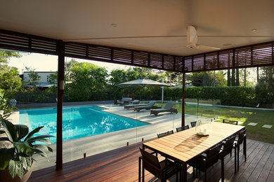 Inspiration for a large contemporary backyard deck in Brisbane with an outdoor kitchen and a roof extension.